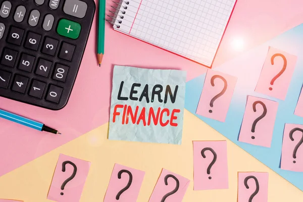Writing note showing Learn Finance. Business photo showcasing study which figures out how showing and business uses money Mathematics stuff and writing equipment above pastel colours background.