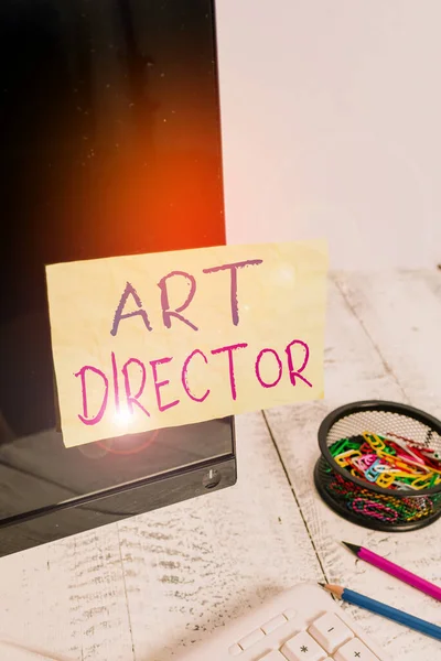Text sign showing Art Director. Conceptual photo responsible for overseeing the artistic aspects of a film Note paper taped to black computer screen near keyboard and stationary.