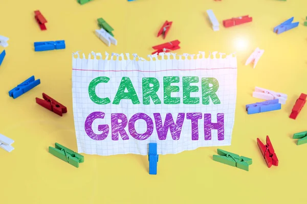 Word writing text Career Growth. Business concept for the process of making progress to better jobs or career Colored clothespin papers empty reminder yellow floor background office.