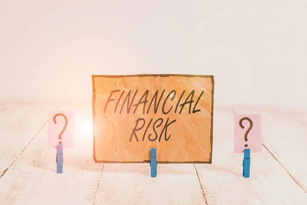 Writing note showing Financial Risk. Business photo showcasing any of various types of risk associated with financing Crumbling sheet with paper clips placed on the wooden table.