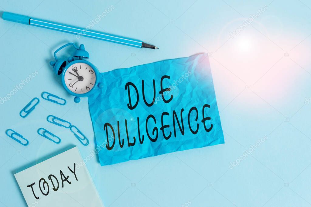 Handwriting text writing Due Diligence. Concept meaning Rational steps taken by a demonstrating to avoid committing a tort Alarm clock clips notepad blank crushed sheet marker sky colored background.
