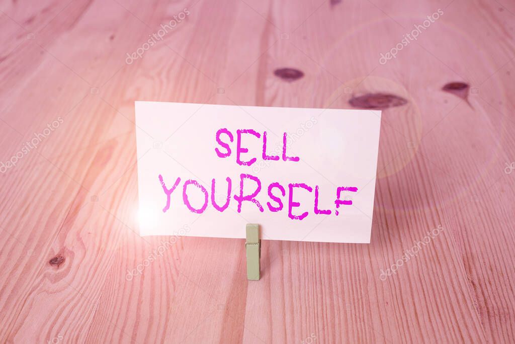 Conceptual hand writing showing Sell Yourself. Business photo showcasing to make yourself seem impressive or notable to other showing Wooden floor background green clothespin groove slot office.