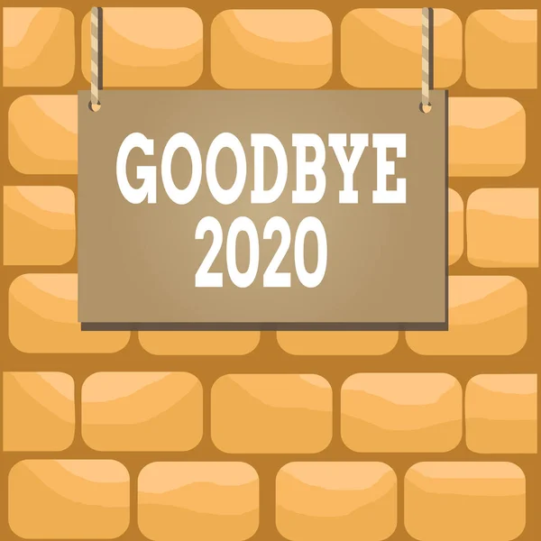 Handwriting text writing Good Bye 2020. Concept meaning express good wishes when parting or at the end of last year Wooden board wood rectangle shape empty frame fixed colorful striped string.