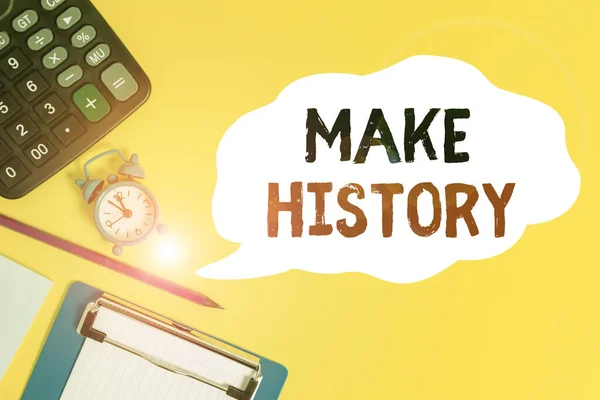 Handwriting text Make History. Concept meaning do something that is remembered in the course of history Alarm clock wakeup calculator pencil clipboard notepad color background.