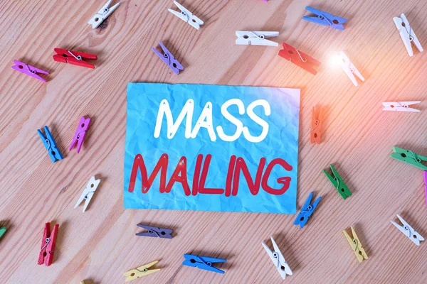 Text sign showing Mass Mailing. Conceptual photo act of sending the same email to a large group of showing Colored clothespin papers empty reminder wooden floor background office.