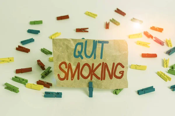 Text sign showing Quit Smoking. Conceptual photo process of discontinuing tobacco smoking or cessation Colored clothespin papers empty reminder white floor background office. — Stock Photo, Image