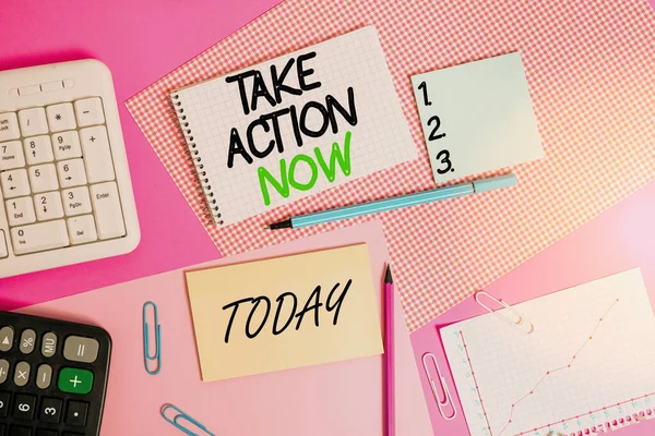 Writing note showing Take Action Now. Business photo showcasing do something official or concerted achieve aim with problem Writing equipments and computer stuffs placed above colored plain table.