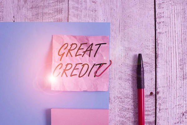 Text sign showing Great Credit. Conceptual photo borrower has high credit score and is a safe credit risk Wrinkle paper and cardboard plus stationary placed above wooden background.