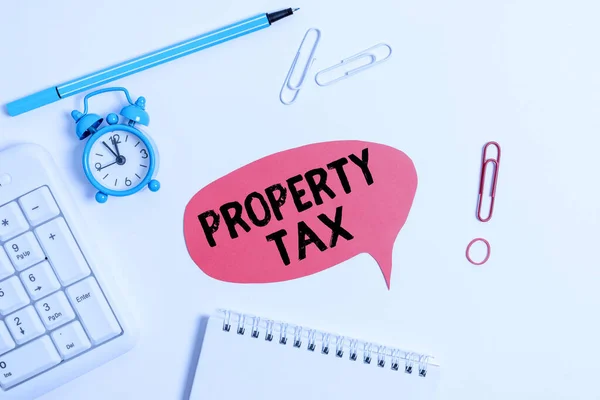 Text sign showing Property Tax. Conceptual photo an ad valorem tax on the value of a property Millage rate Copy space on the empty note paper with pc keyboard clock and pencil on the table.