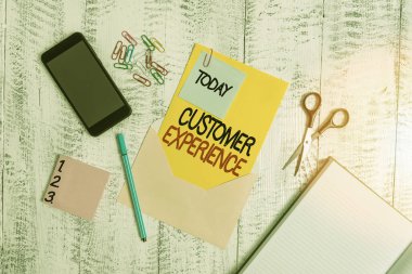 Kelime yazma Müşteri Deneyimi. Organizasyon ve alıcı arasındaki etkileşim ürünü için iş konsepti Zarf akıllı telefon notları kalem raptiyesi makasları ahşap.