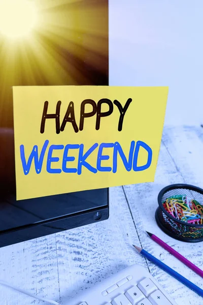 Text sign showing Happy Weekend. Conceptual photo something nice has happened or they feel satisfied with life Note paper taped to black computer screen near keyboard and stationary.