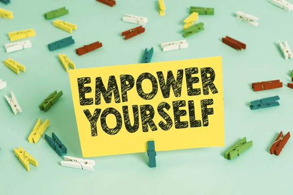 Text sign showing Empower Yourself. Conceptual photo taking control of our life setting goals and making choices Colored clothespin papers empty reminder blue floor background office pin. — Stock Photo, Image