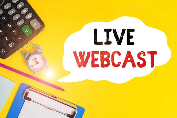 Handwriting text Live Webcast. Concept meaning the process of video broadcasting live over the internet Alarm clock wakeup calculator pencil clipboard notepad color background.