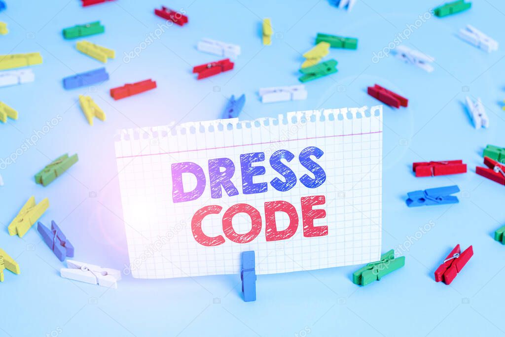 Writing note showing Dress Code. Business photo showcasing an accepted way of dressing for a particular occasion or group Colored clothespin papers empty reminder blue floor officepin.