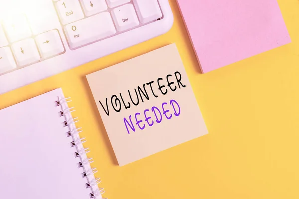 Writing note showing Volunteer Needed. Business photo showcasing asking demonstrating to work for organization without being paid Empty papers with copy space on yellow background table. — Stock Photo, Image