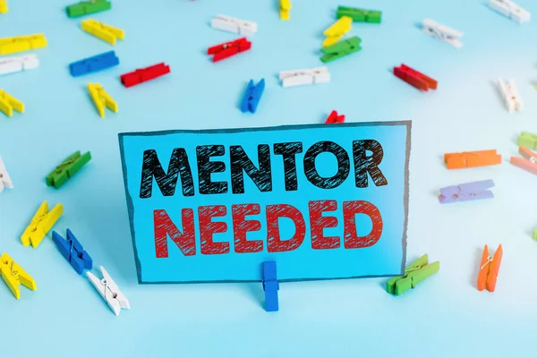 Writing note showing Mentor Needed. Business photo showcasing Employee training under senior assigned act as advisor Colored clothespin papers empty reminder blue floor officepin.