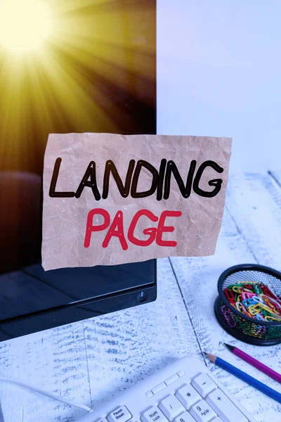 Text sign showing Landing Page. Conceptual photo Web page that a user arrives at after clicking a hyperlink Note paper taped to black computer screen near keyboard and stationary. — Stock Photo, Image