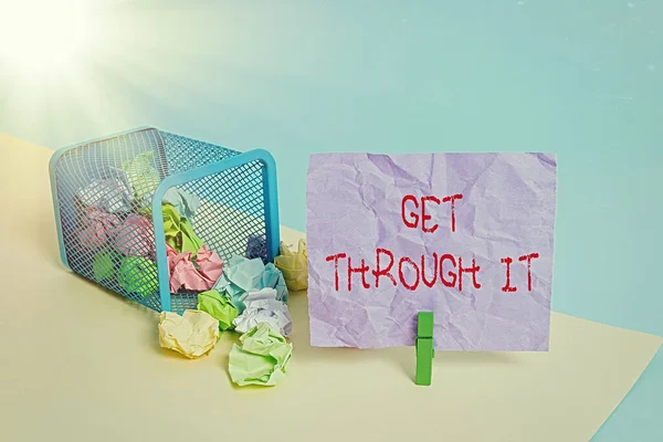 Writing note showing Get Through It. Business photo showcasing enourage someone to succeed in passing or surviving Trash bin crumpled paper clothespin reminder office supplies.