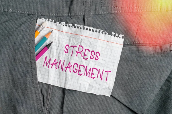 Writing note showing Stress Management. Business photo showcasing method of limiting stress and its effects by learning ways Writing equipment and white note paper inside pocket of trousers.