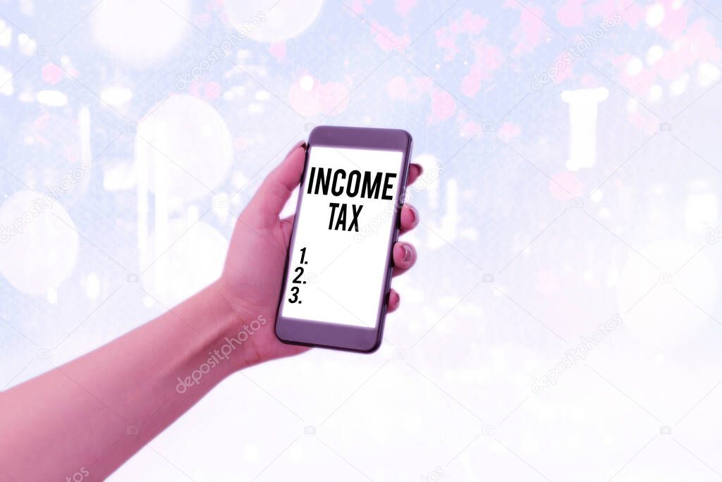 Handwriting text Income Tax. Concept meaning Annual charge levied on both earned and unearned income.