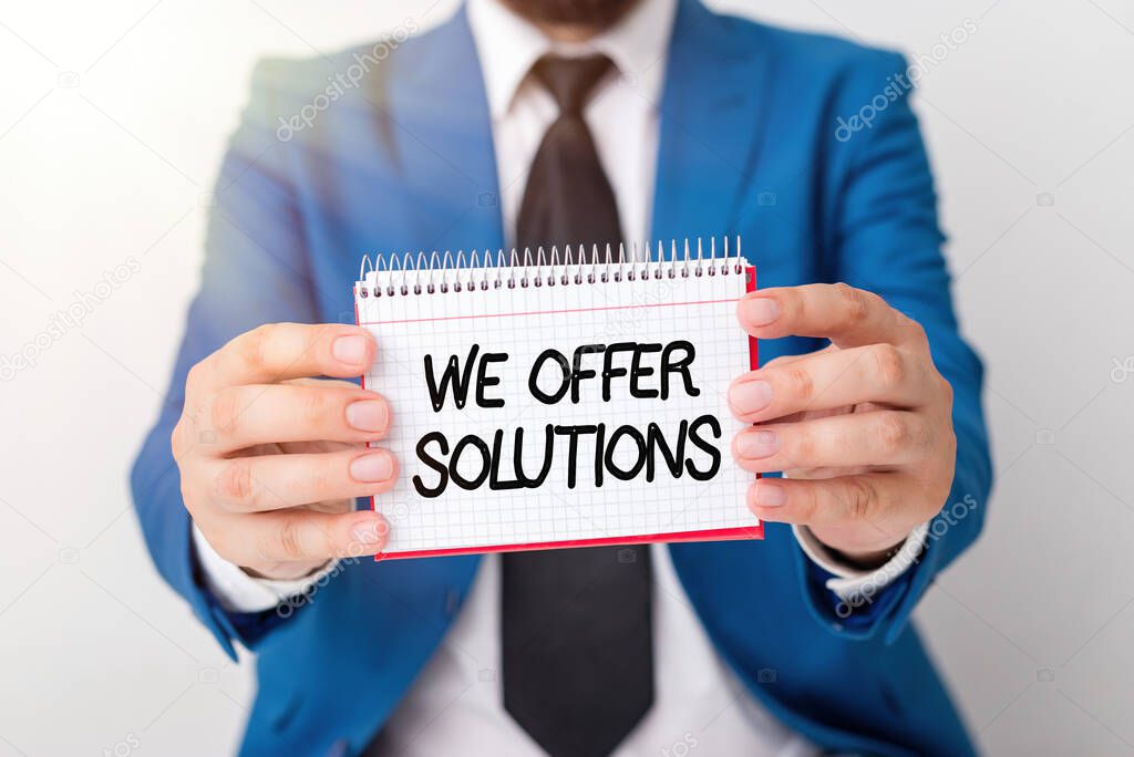 Writing note showing We Offer Solutions. Business photo showcasing way to solve problem or deal with difficult situation Man holds empty paper with copy space in front of him Space.