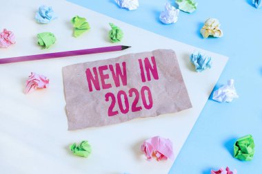 Yeni Yıl 2020 'yi gösteren mesaj işareti. 2020 yılı için beklenen kavramsal fotoğraf veya yeni yaratılış Renkli buruşmuş kağıtlar boş mavi sarı arka plan çamaşır mandalı.