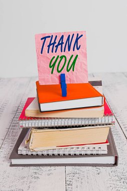 Word writing text Thank You. Business concept for a polite expression used when acknowledging a gift or service pile stacked books notebook pin clothespin colored reminder white wooden. clipart