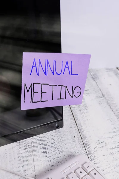 Text sign showing Annual Meeting. Conceptual photo yearly meeting of the general membership of an organization Notation paper taped to black computer monitor screen near white keyboard.