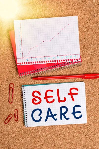 Handwriting text Self Care. Concept meaning the practice of taking action to improve one own health Desk notebook paper office cardboard paperboard study supplies table chart. — Stock Photo, Image