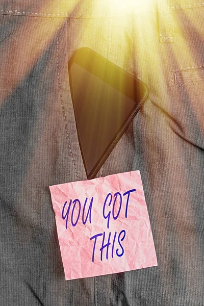 Text sign showing You Got This. Conceptual photo to encourage someone to succeed in dealing with something Smartphone device inside formal work trousers front pocket near note paper.