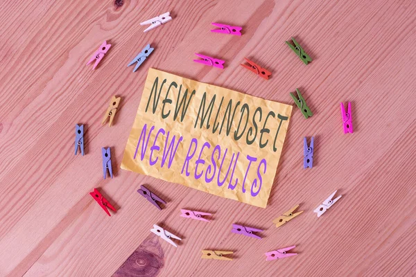 Writing note showing New Mindset New Results. Business photo showcasing obstacles are opportunities to reach achievement Colored clothespin papers empty reminder wooden floor background office. — Stock Photo, Image