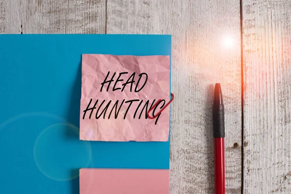 Text sign showing Head Hunting. Conceptual photo process of recruitment of a prospective or potential employee Wrinkle paper and cardboard plus stationary placed above wooden background.