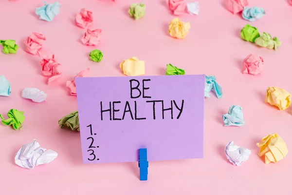 Handwriting text writing Be Healthy. Concept meaning to be vigorous and totally free from bodily or mental diseases Colored crumpled papers empty reminder pink floor background clothespin. — Stock Photo, Image