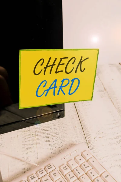 Writing note showing Check Card. Business photo showcasing allows an account holder to access funds in her account Notation paper computer monitor screen near white keyboard. — Stock Photo, Image