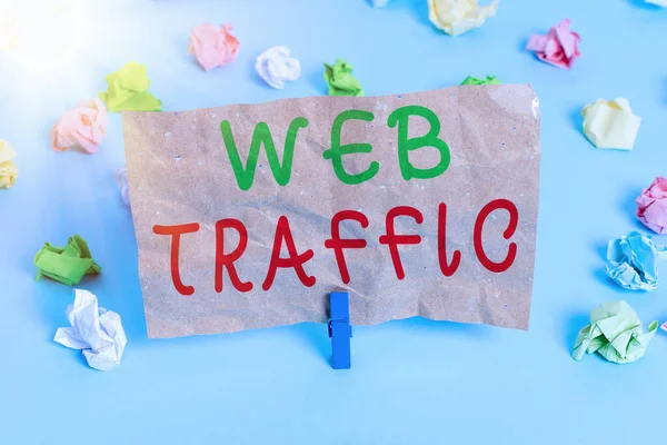 Text sign showing Web Traffic. Conceptual photo the amount of data sent and received by visitors to a website Colored crumpled papers empty reminder blue floor background clothespin.