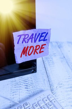 Travel More 'u gösteren kavramsal el yazısı. İş fotoğrafı gösterimi Bir yolculuk yapmak için sıklıkla seyahat özellikle uzun mesafe notasyon kağıt monitör ekranı beyaz klavye yanında.