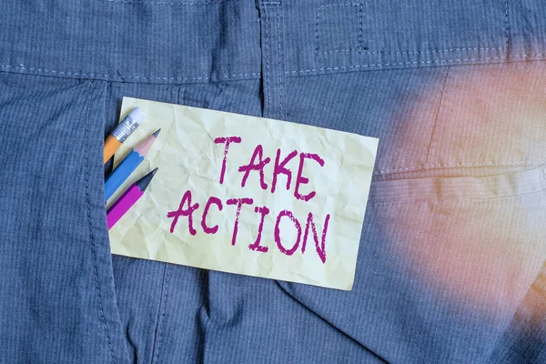 Word writing text Take Action. Business concept for do something official or concerted to achieve aim with problem Writing equipment and yellow note paper inside pocket of man work trousers.