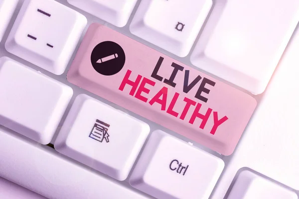 Texto de escritura de palabras Live Healthy. Concepto de negocio para uno que ayuda a mantener y mejorar las demostraciones es la salud o condición . — Foto de Stock