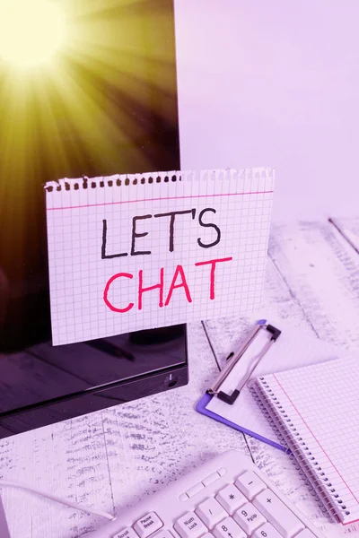 Writing note showing Lets Is Chat. Business photo showcasing inviting the demonstrating to have informal conversation with you Note paper taped to black computer screen near keyboard and stationary.