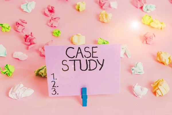 Handwriting text writing Case Study. Concept meaning research methodology that has commonly used in social sciences Colored crumpled papers empty reminder pink floor background clothespin.