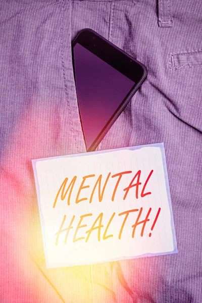 Conceptual hand writing showing Mental Health. Business photo text demonstratings condition regard to their psychological well being Smartphone device inside trousers front pocket note paper.