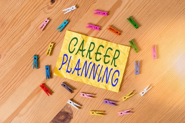 Writing note showing Career Planning. Business photo showcasing Strategically plan your career goals and work success Colored clothespin papers empty reminder wooden floor background office.