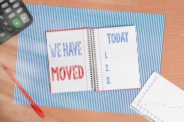 Handwriting text writing We Have Moved. Concept meaning To go from one residence or location to another Relocate Striped paperboard notebook cardboard office study supplies chart paper.