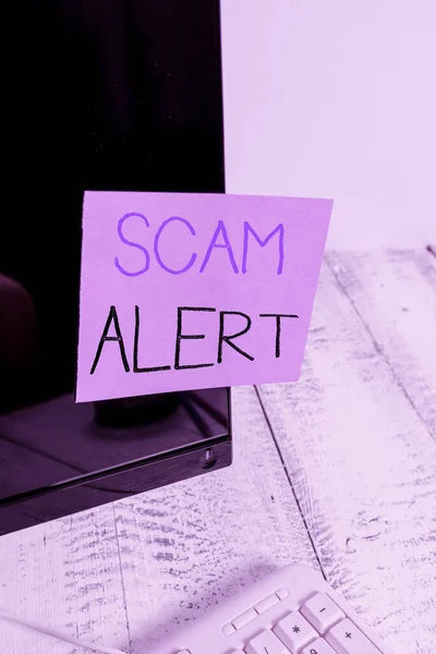 Text sign showing Scam Alert. Conceptual photo unsolicited email that claims the prospect of a bargain Notation paper taped to black computer monitor screen near white keyboard.