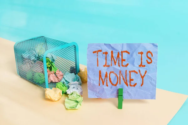 Writing note showing Time Is Money. Business photo showcasing time is a valuable resource Do things as quickly as possible Trash bin crumpled paper clothespin reminder office supplies.