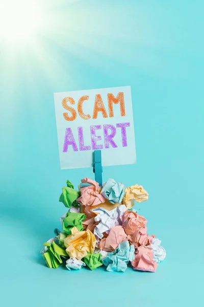 Writing note showing Scam Alert. Business photo showcasing unsolicited email that claims the prospect of a bargain Reminder pile colored crumpled paper clothespin wooden space.