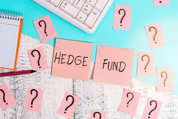 Text sign showing Hedge Fund. Conceptual photo basically a fancy name for an alternative investment partnership Writing tools, computer stuff and math book sheet on top of wooden table.