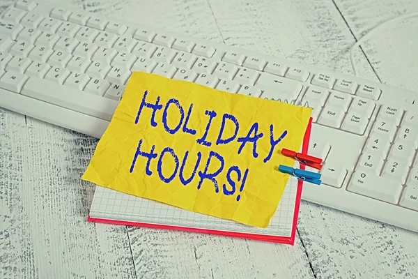 Conceptual hand writing showing Holiday Hours. Business photo showcasing employee receives twice their normal pay for all hours notebook reminder clothespin with pinned sheet light wooden. — Stock Photo, Image
