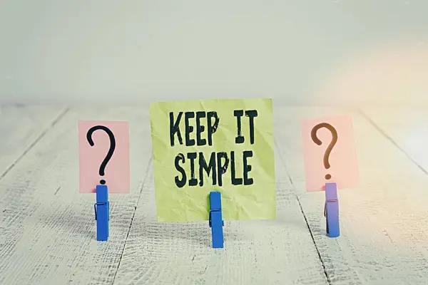 Text sign showing Keep It Simple. Conceptual photo ask something easy understand not go into too much detail Scribbled and crumbling sheet with paper clips placed on the wooden table. — Stock Photo, Image