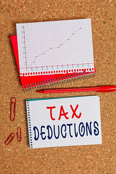 Handwriting text Tax Deductions. Concept meaning an amount or cost that subtracted from someone income Desk notebook paper office cardboard paperboard study supplies table chart. — Stock Photo, Image